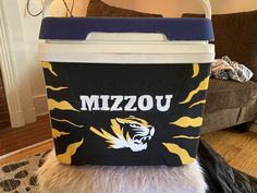 a black and yellow cooler with the word mizzo on it