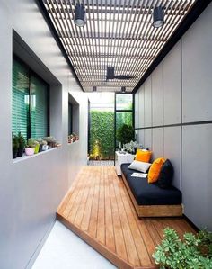 an outdoor living area with wood flooring and white walls