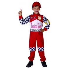 a young boy dressed in a racing suit and giving the peace sign with his hand