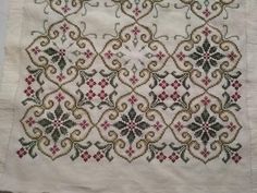 an embroidered piece of cloth with designs on it