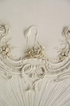 an ornate ceiling with white paint on it