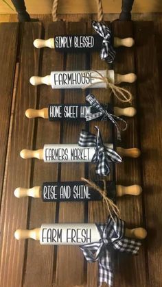 some wooden spoons are tied up to a board with words on them that read, mom's post