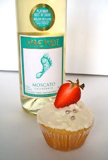 a cupcake next to a bottle of wine