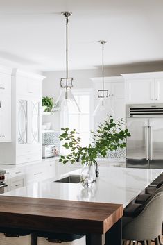 a kitchen with white cabinets and an island