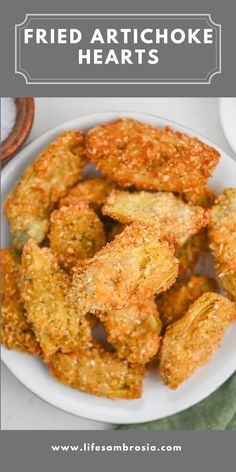 fried artichoke hearts in a white bowl with text overlay that reads, fried artichoke hearts