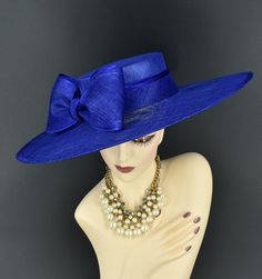 Note: The design of this hat, particularly the shallower crown, was crafted to create a unique aesthetic that suits some individuals perfectly. However, if you notice that the hat tends to slip, I would advise attaching an elastic strap to ensure a more secure and comfortable fit. ✿*.Key Features.*✿ This is a wide flat brim hat!! It's made of sinamay (3 layers ) and satin.  A nice sinamay bow is trimmed with satin ribbon too, very cool, one of my favorite hats! High quality. It's more beautiful in person! Great for Kentucky derby, weddings, church, Easter, Royal Ascot, horse races, cocktails, tea party, or any hat wearing occasion. Hat base size: From front to back: 19" (48cm) From left to right: 18.25" (46cm) Wide brim appr: 6" (15cm) Crown Depth: 3.5" (9cm) Hat girth: 21" (53.34cm). It f Blue Straw Hat For Summer Parties, Adjustable Blue Costume Hats With Curved Brim, Formal Sinamay Brimmed Boater Hat, Blue Curved Brim Mini Hat For Kentucky Derby, Blue Structured Crown Hat For Spring, Sinamay Boater Hat For Church And Royal Ascot, Blue Spring Hat With Structured Crown, Spring Blue Hat With Structured Crown, Blue Adjustable Costume Hats With Short Brim