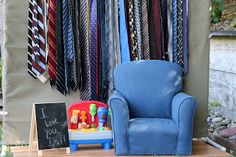 a blue chair sitting next to a pile of ties