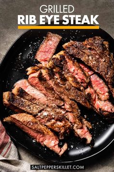 grilled rib eye steak on a black plate with text overlay that reads grilled rib eye steak