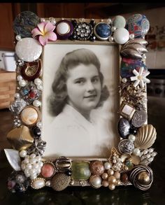 an old photo frame with shells and seashells around it