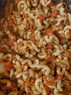 a pan filled with pasta and meat covered in sauce