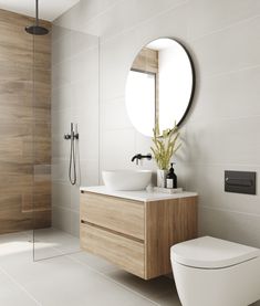 a bathroom with a toilet, sink and mirror in it's center piece is shown