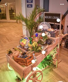 a wooden cart filled with lots of food on top of a hard wood floored floor