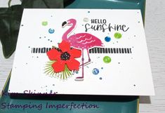 a card with a pink flamingo on it sitting on top of a green tray