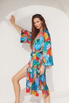 Tropical print satin kimono featuring a stash at the waist. NOTE: If your size is not available, please register your email in EMAIL ME WHEN AVAILABLE link. Multicolor Tropical Print Kimono, Beach Kimono With Satin Material, Beach Kimono With Satin And Kimono Sleeves, Beach Kimono With Satin Material And Kimono Sleeves, Tropical Printed Kimono With Kimono Sleeves, Beach Satin Kimono, Multicolor Floral Print Robe For Vacation, Satin Kimono With Kimono Sleeves For The Beach, Vacation Kimono With Vibrant Print