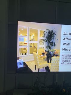 a television screen showing a living room and dining area with yellow chairs in front of it