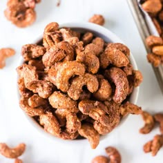 a white bowl filled with nuts on top of a table