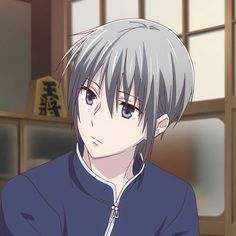 an anime character with grey hair and blue eyes looks at the camera while standing in front of a window