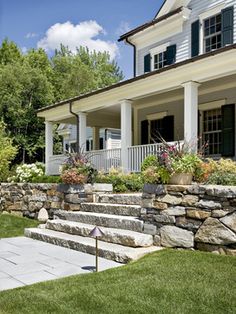 stone steps lead up to the front door of a house