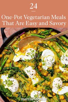 a skillet filled with eggs and asparagus on top of a red table cloth