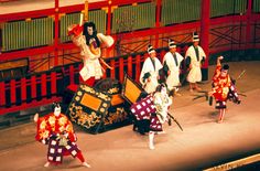 performers in traditional japanese costumes perform on stage