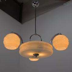 three lights hanging from a ceiling in a room