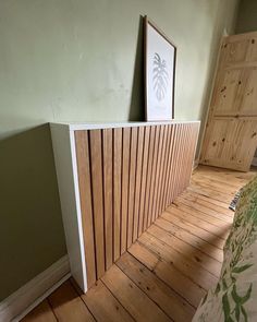 a bed room with a wooden floor and green walls