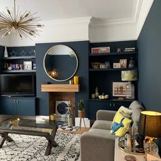 a living room filled with furniture and a flat screen tv mounted on a wall next to a fire place