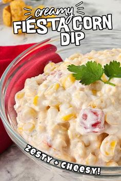 a bowl filled with corn dip and garnished with cilantro on top