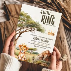 a person holding up a little king book