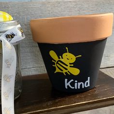 a potted plant sitting on top of a wooden shelf next to a mason jar