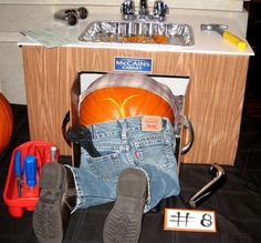 a pair of jeans sitting in front of a sink filled with pumpkins and other items