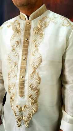 a man wearing a white and gold outfit