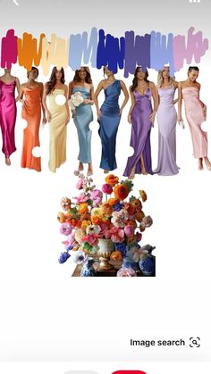 a group of women standing next to each other in front of a bunch of flowers