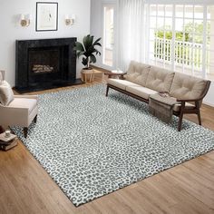 a living room with white furniture and a black and white area rug on the floor