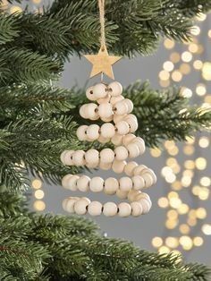 a christmas tree ornament hanging from a pine tree