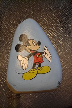 a mickey mouse painted on top of a rock