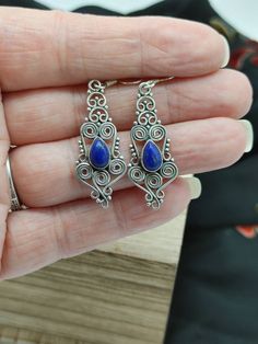 "Beautiful curves of rolling silver and a teardrop shaped lapis lazuli stone make these earrings an ornate design, origin unknown stamped 925 on back with sterling silver ear wires. Length 2\" Drop 1 1/2\" Width 1/2 Weight 4.8 grams" Brass Hoop Earrings, Ornate Design, Lapis Lazuli Stone, Onyx Earrings, Mothersday Gifts, Beautiful Curves, Dainty Earrings, Blue Earrings, Vintage Earrings