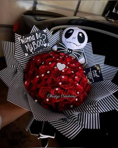 a bouquet of red roses in the shape of a skull and jack skellingy