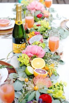 the table is decorated with flowers and fruit