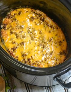 a crock pot filled with meat and cheese