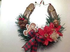 a christmas wreath with gingerbreads, pine cones and other holiday decorations on it