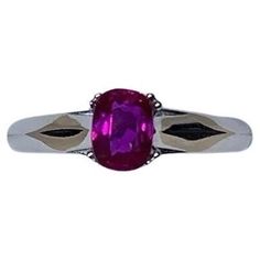 a ring with a pink stone in the center