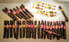 there are many different types of cigars on the table with stickers around them