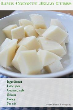 a white bowl filled with cubed cheese on top of a table