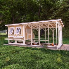 a chicken coop in the middle of a grassy area with trees and grass around it