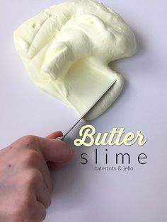 a person cutting butter on top of a white board