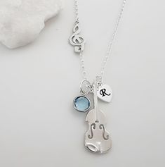 Add some music to your life this Treble Clef Necklace is Personalized with birthstones and initials that are perfect to express joy, love, thrill and passion Needless to say they will be a gorgeous gift for music lovers, Music Teachers, Students so on. ツ  Last pic is the violin at the back. MONYART ORIGINAL DESIGN. Truly one of a kind! Please sellers don't copy! ツ Trust in yourself....make your own designs!! You are awesome!! :)  Copyright author. LIKE THIS ITEM?  Save it and revisit it later Th Music-themed Sterling Silver Necklace, Silver Sterling Music-themed Necklace, Silver Music-themed Charm Jewelry, Nickel-free Sterling Silver Music-themed Necklace, Silver Music-themed Jewelry With Charms, Pinterest Button, Treble Clef Necklace, Music Teachers, Infinity Design