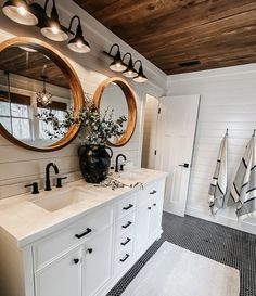 a bathroom with two sinks and mirrors in it