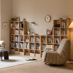 a living room filled with furniture and bookshelves next to a wall mounted clock