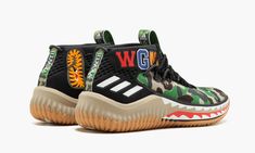 Streetwear legends BAPE teamed up with adidas Basketball for the first time in 2018, presenting the BAPE x adidas Dame 4 collection.  Featuring BAPE’s signature shark and camouflage graphics, Damian Lillard’s fourth signature shoe transformed into a hypebeast’s dream, easily becoming the most wanted set of releases in the history of Lillard’s sneaker line by far.  Here we have the green camo edition, featuring BAPE’s famous camouflage motif across the upper, shark tooth graphic on the midsole, a Bape Sneakers, Camo Shoes, Sneakers Green, Perfect Sneakers, Tiger Logo, Orange Decor, Wavy Lines, Limited Edition Sneakers, Shark Tooth